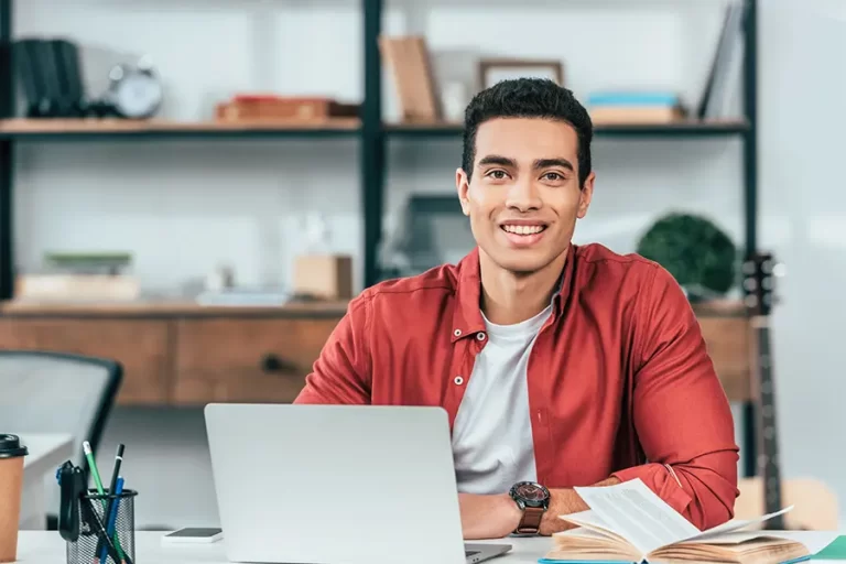 Smiling student working on the computer